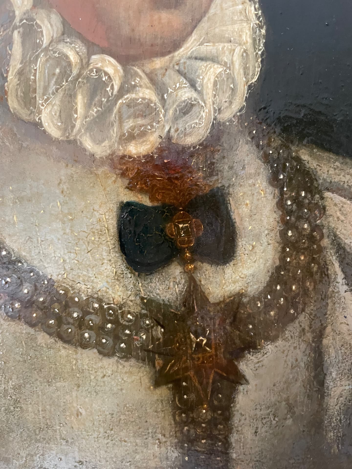 Detail of the sitter's ruff and jewel