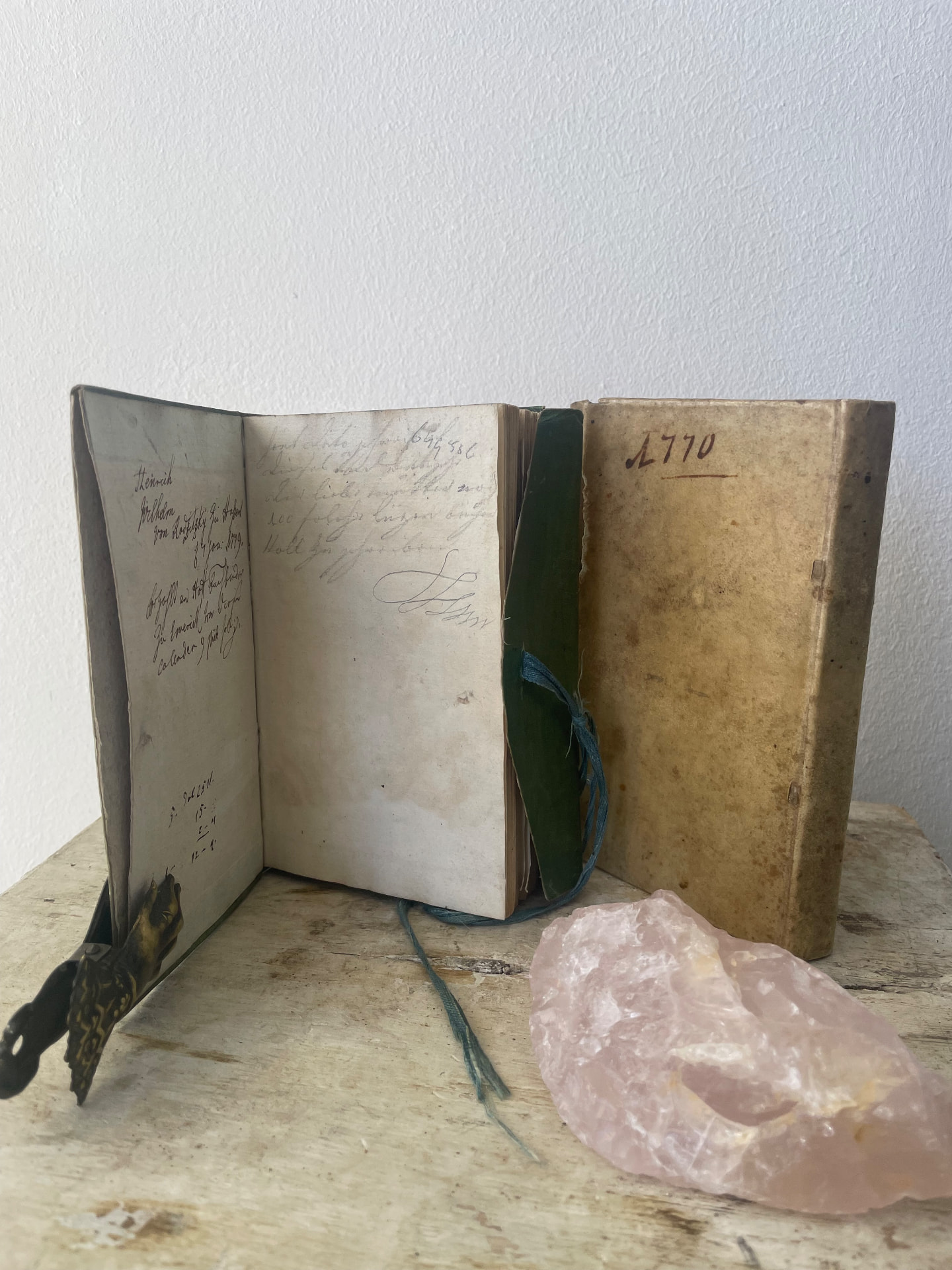 The original green paste-paper wrapper of the 1779 almanac with its silk tie